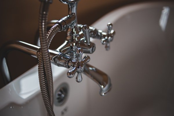 Chrome bathtub faucet closeup — toilet, faucet, fixture and re-piping work Toronto